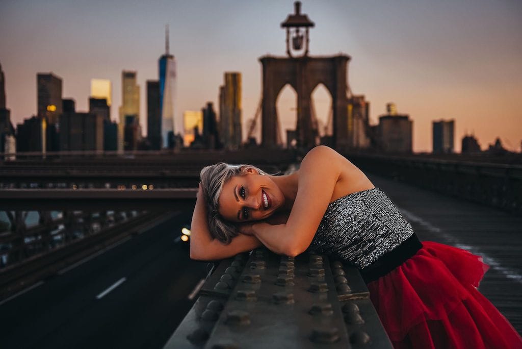 Girl on the Brooklyn Bridge in a red tulle skirt; NYC