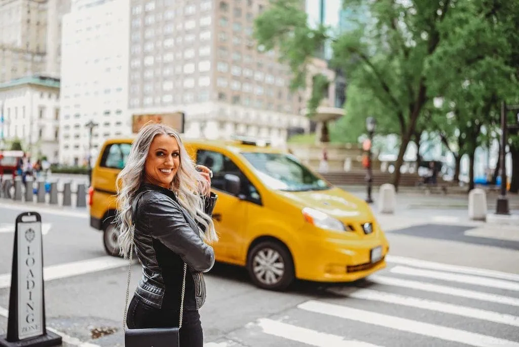 Girl hailing a taxi in New York City