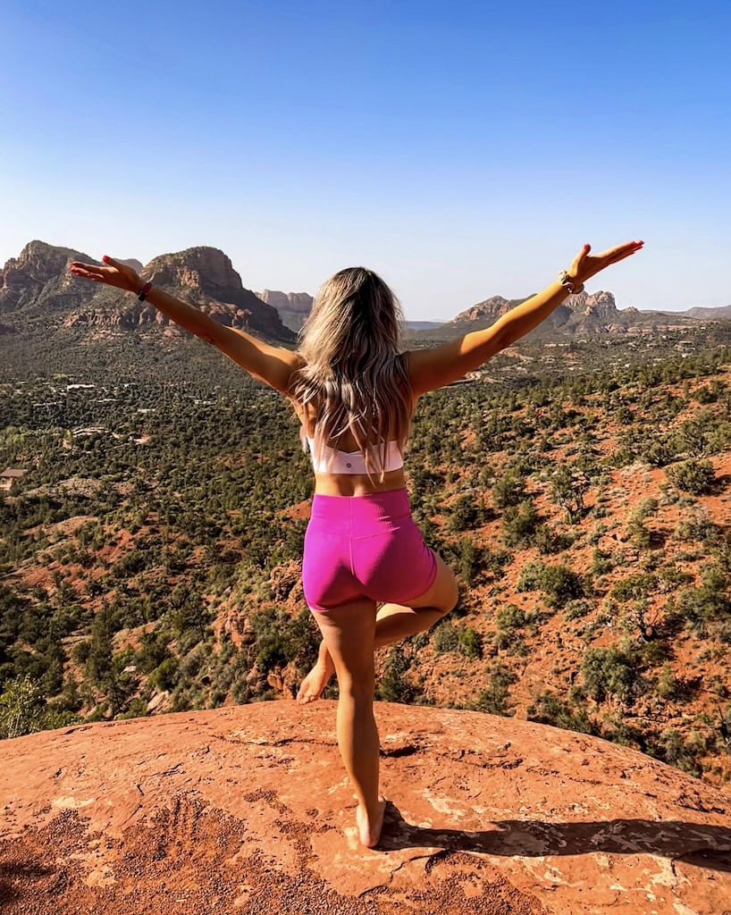 Doing tree pose during yoga on the Airport Mesa Vortex in Sedona, AZ