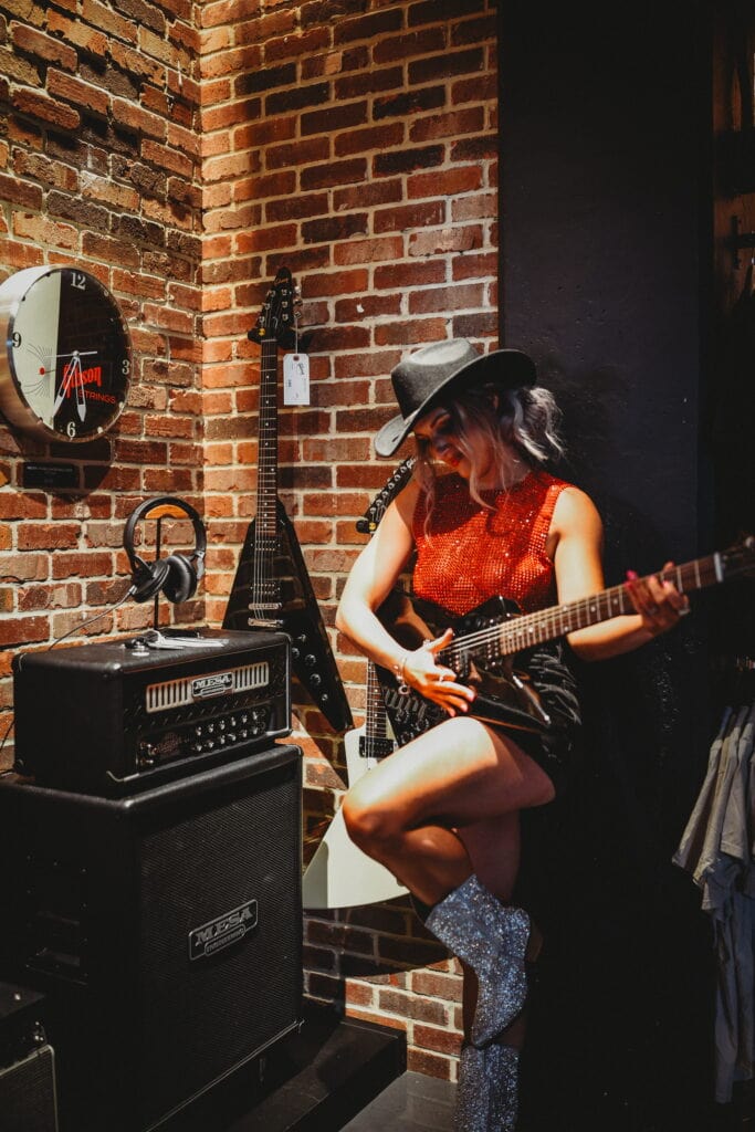 Girl holding a guitar at Gibson Guitar Nashville during a musician photoshoot