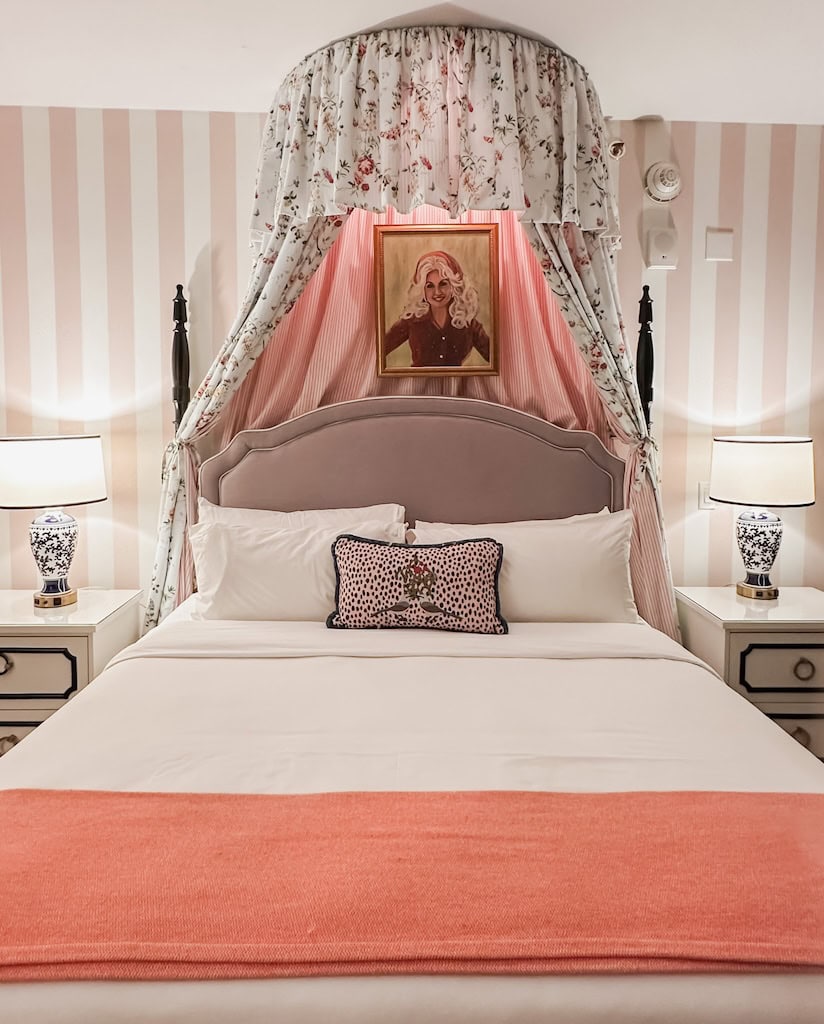 Bed inside The Graduate Nashville with a photo of Dolly Parton