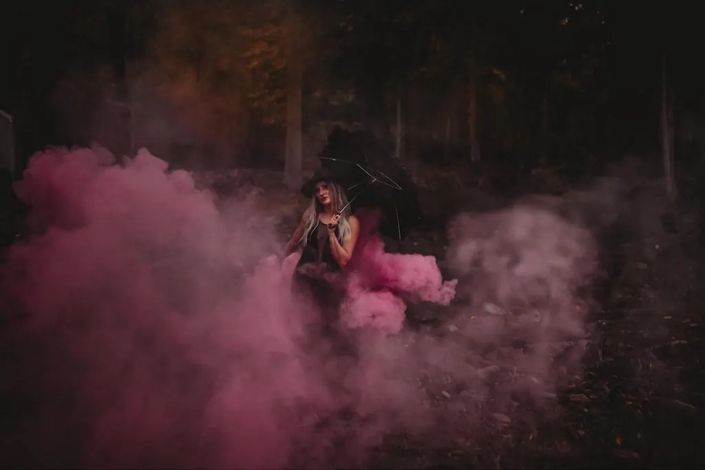 Girl using smoke bombs in photos for a Halloween photoshoot