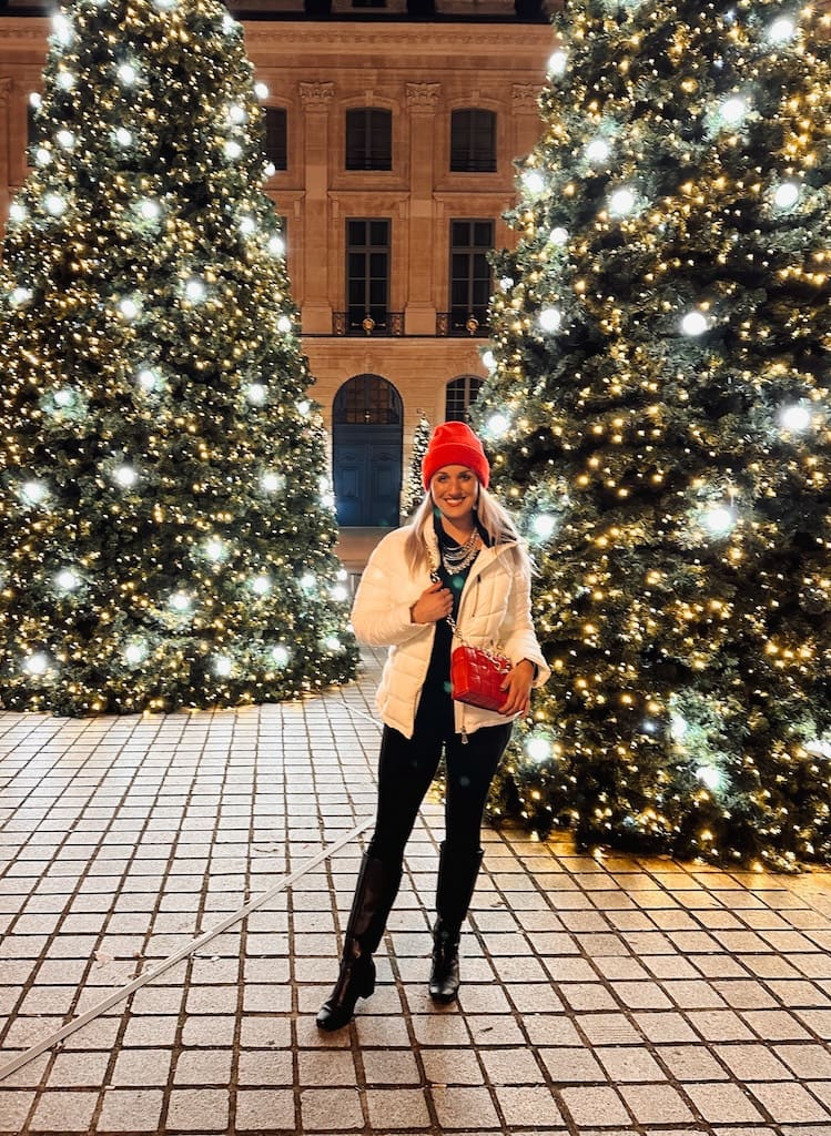 Girl with Christmas trees in Place Vendôme; Paris, France