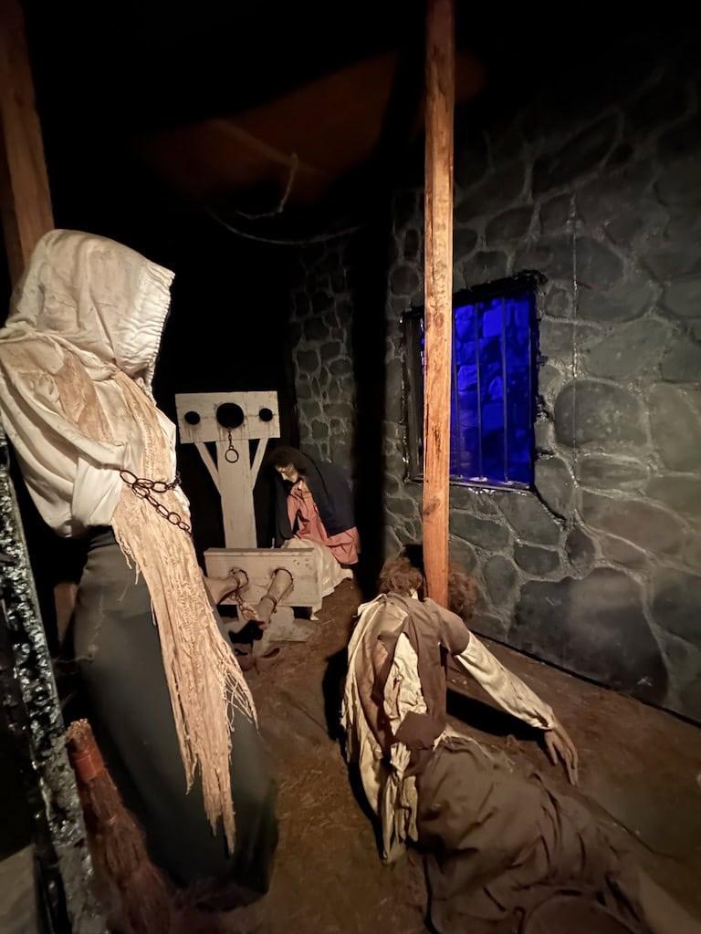 A replica of one of the cells + prisoners inside the Witch Dungeon Salem