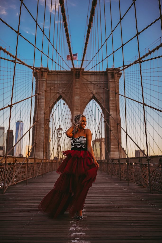 Girl in a red tulle skirt on the Brooklyn Bridge, NYC