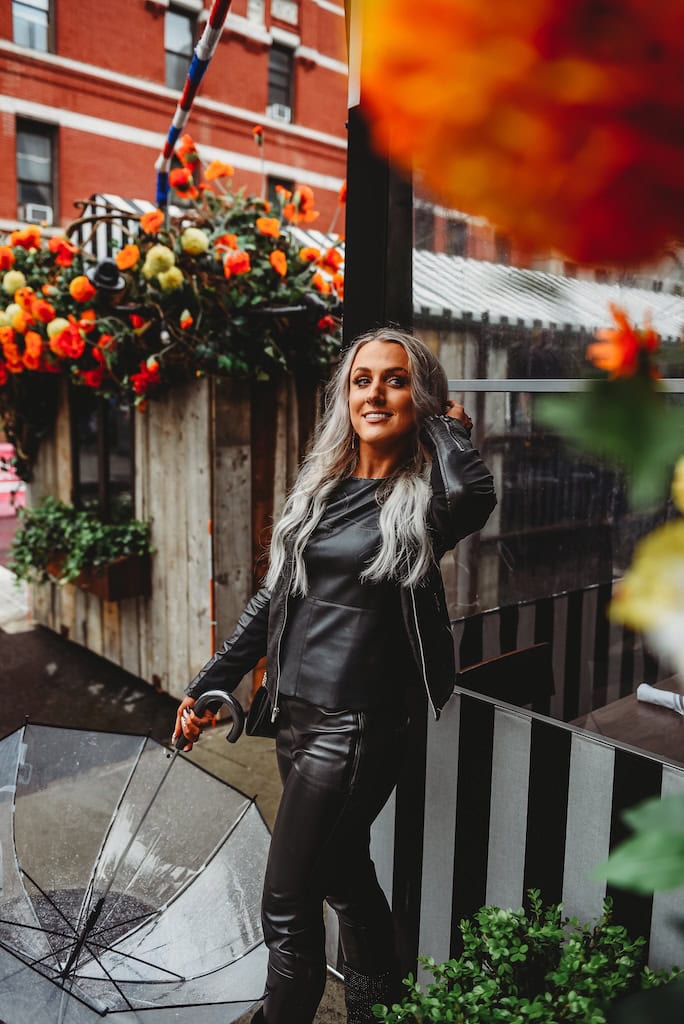 Girl standing outside a building with flowers in NYC