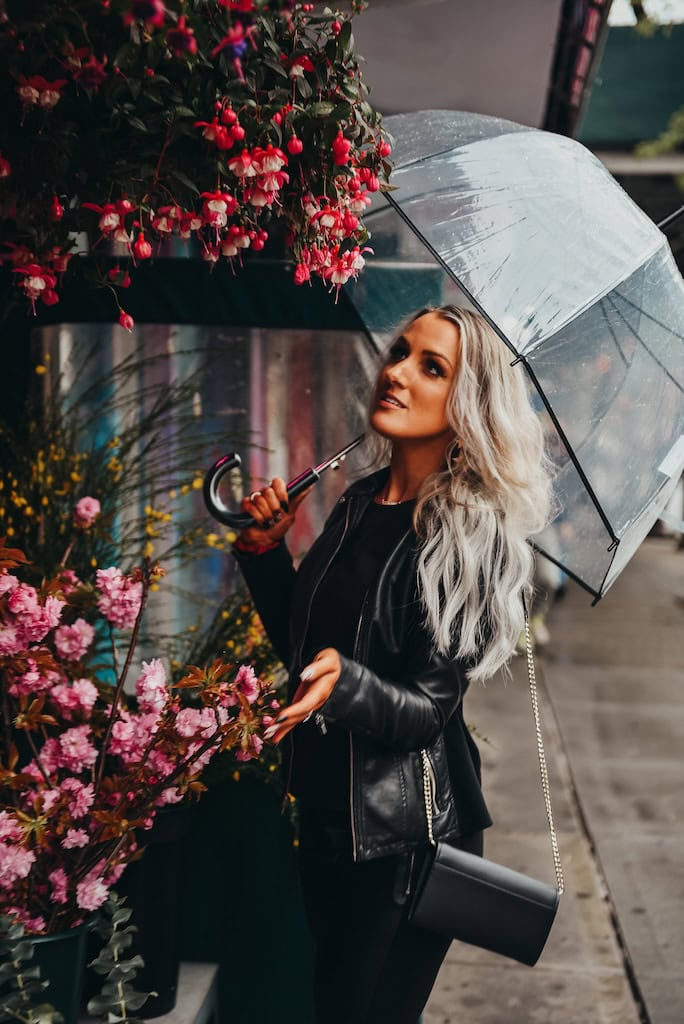 Girl standing outside a building with flowers in NYC