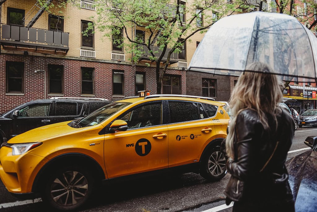 Girl hailing a taxi in New York City