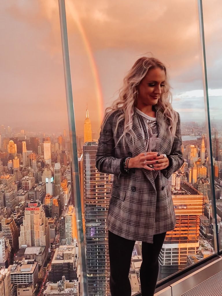 Girl with the Manhattan Skyline and a rainbow in the background