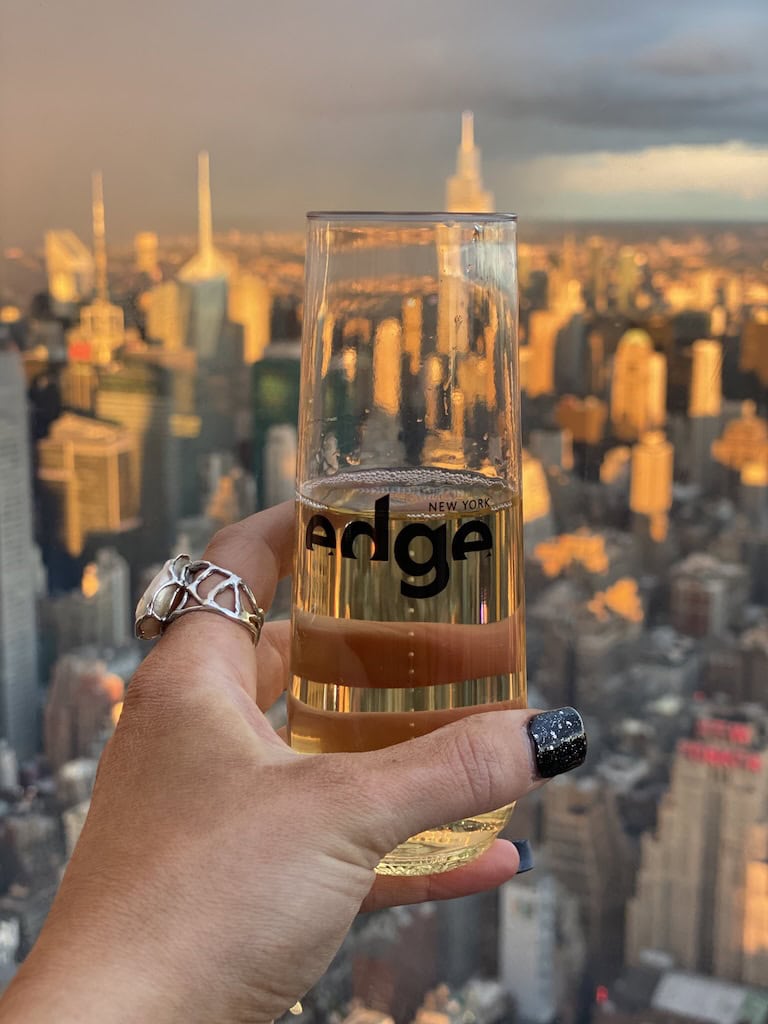 Raising a glass of champagne over NYC at The Edge