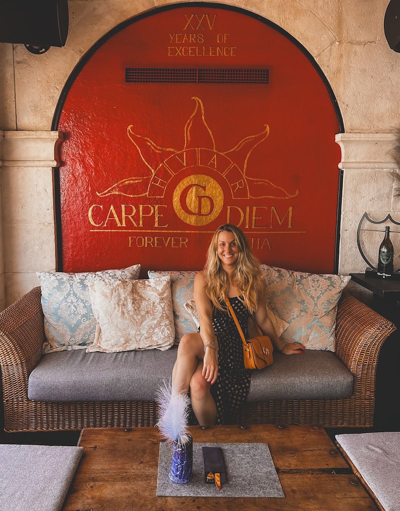 Girl sitting at Carpe Diem Hvar, Croatia