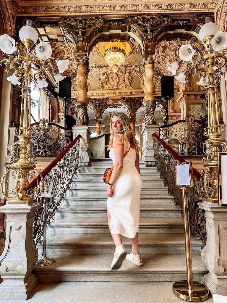 Girl on the steps of New York Cafe - Budapest, Hungary