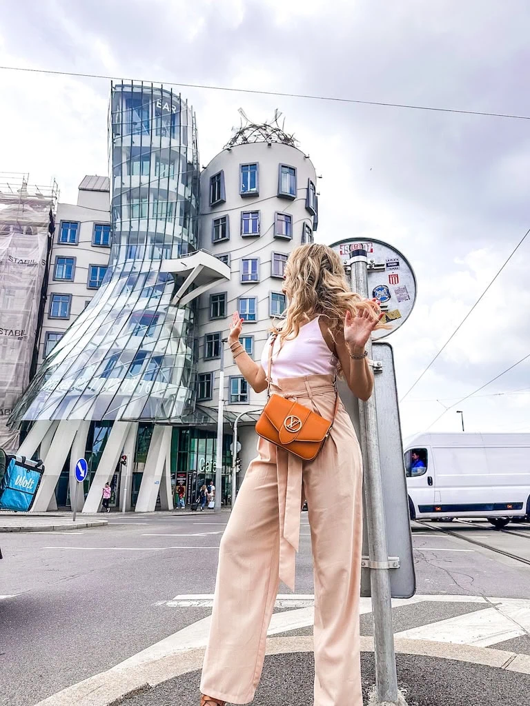Girl in front of the Dancing House in Prague