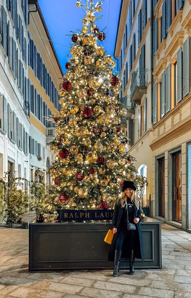 Girl by the Ralph Lauren Christmas tree near Via della Spiga in Milan, Italy