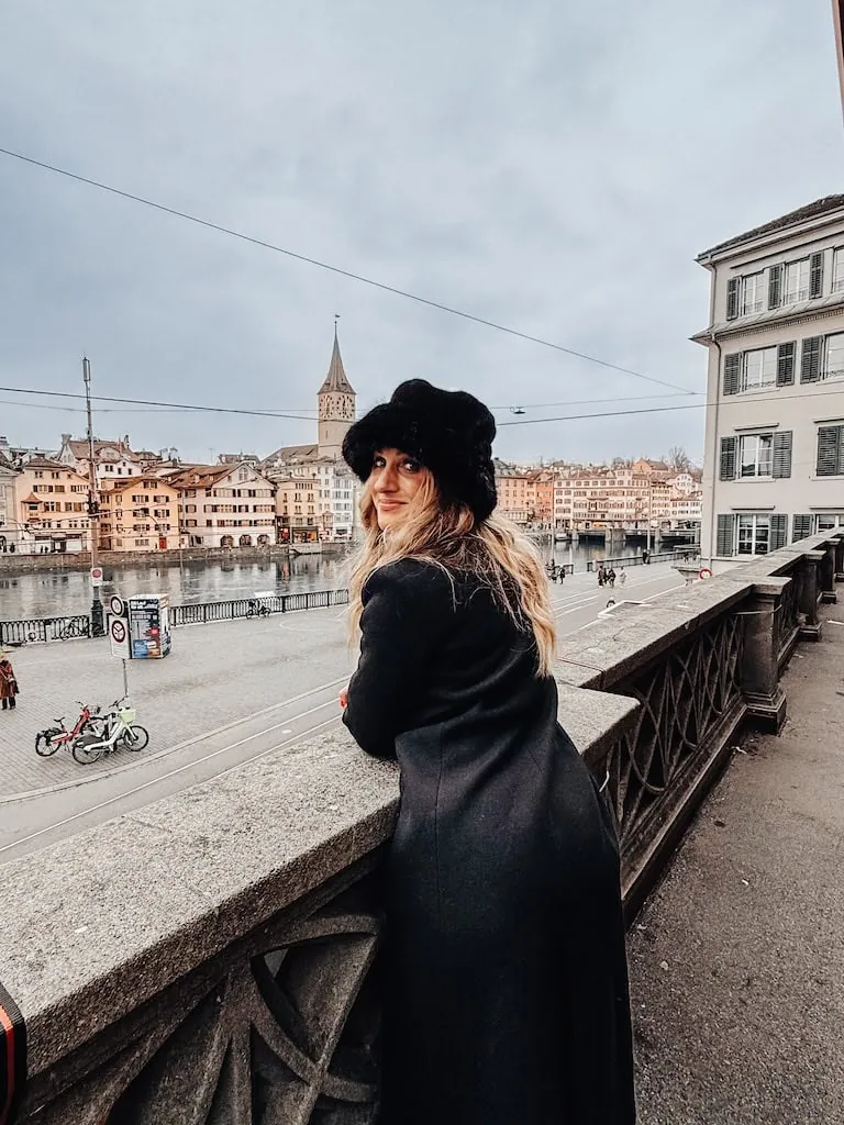Girl standing in front of the river in Old Town Zurich, Switzerland