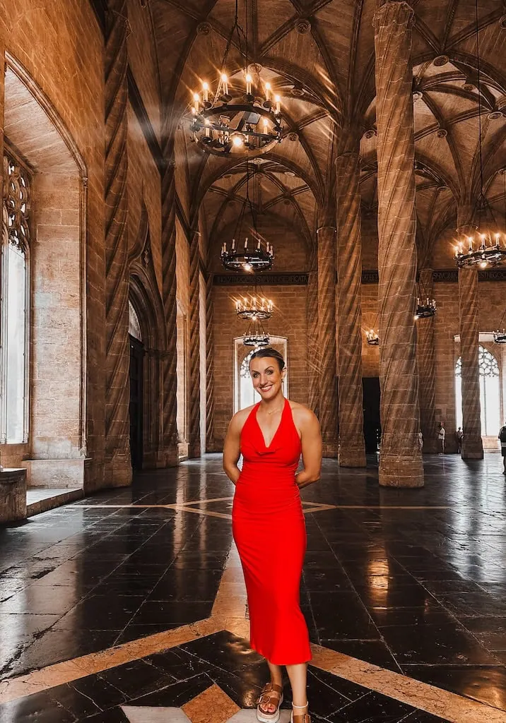 Girl standing inside The Silk Exchange (La Lonja de la Seda) in Valencia, Spain