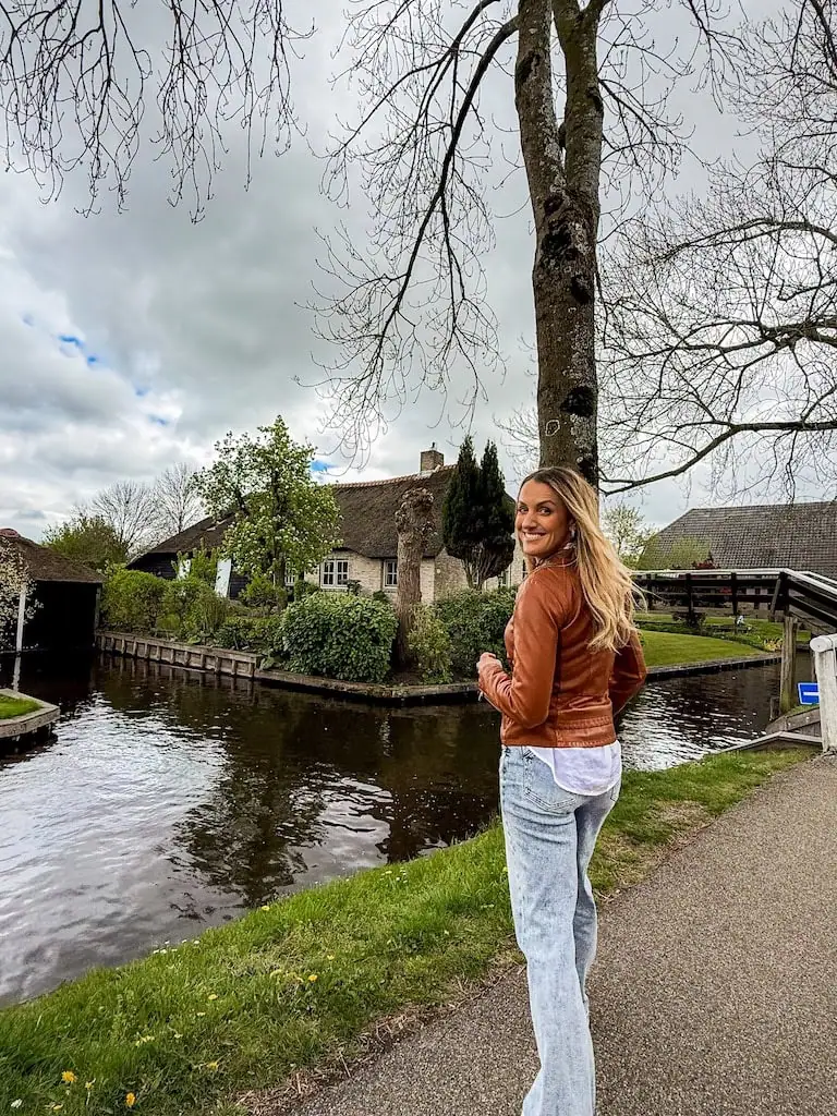 Girl standing by the canals in Giethoorn Village, Netherlands