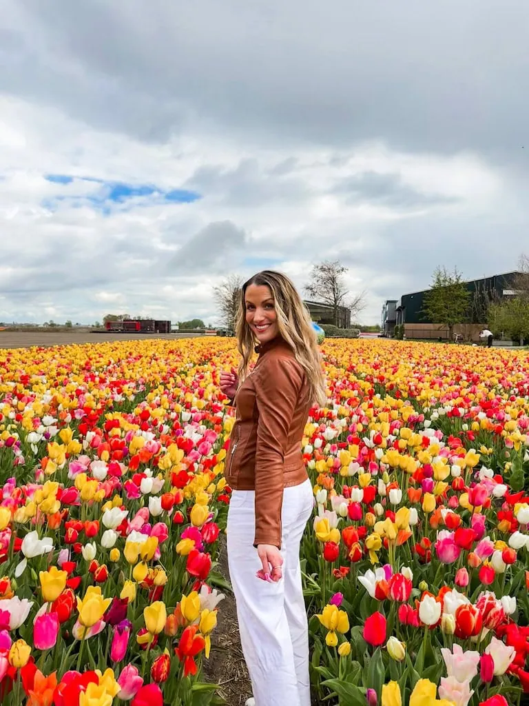 Girl standing in a tulip field in Lisse, Netherlands