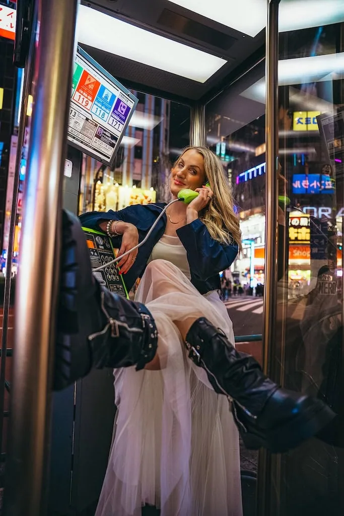 Girl in a phone booth in Tokyo, Japan