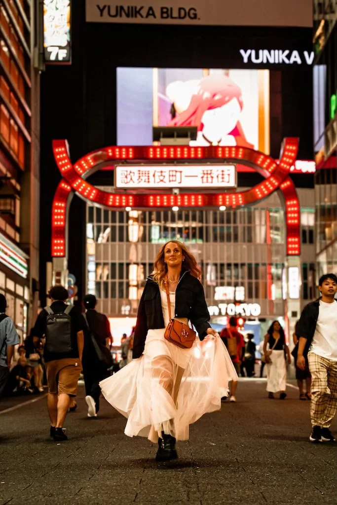 Girl walking through Kabukicho; Tokyo, Japan