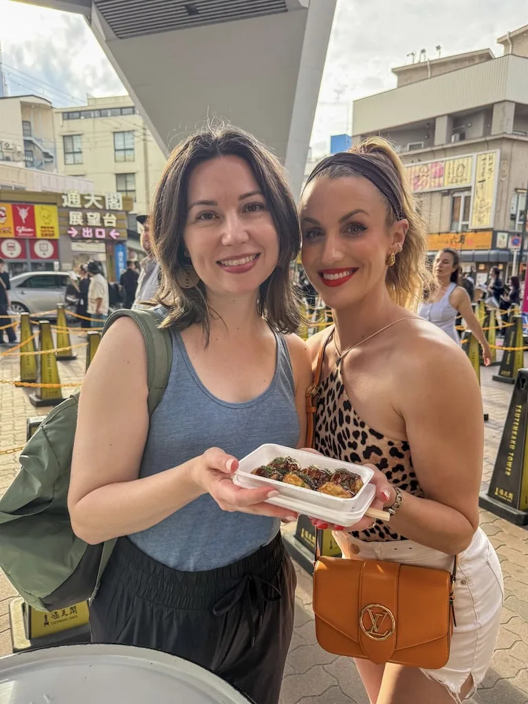 2 girls with food in Osaka, Japan